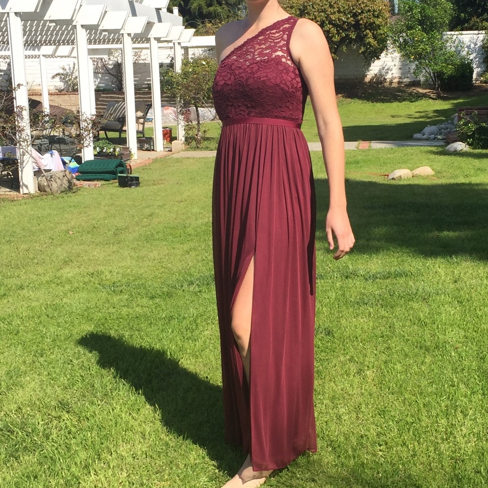 One shoulder, wine colored, floor length dress.